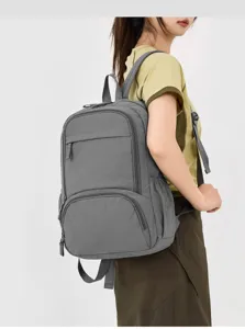 Close-up detail view of the grey casual backpack worn by model, showing durable daily use.