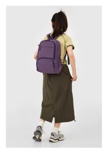 Backpack detail view showing the purple fabric, zippers, and shoulder strap construction.