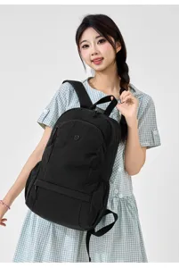 Close-up detail of the black casual nylon backpack showcasing front pocket and sleek design.