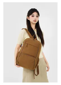Brown canvas casual backpack detail view worn by a model, great for daily school and travel use.