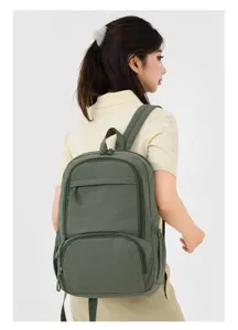 Casual army green nylon backpack with multiple zipper compartments shown worn on back.