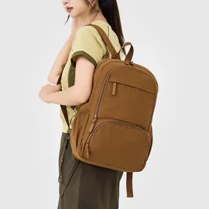 Casual minimalist brown canvas backpack designed for daily commute, school, and travel use.