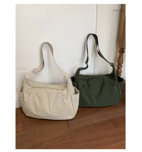 Closeup view of casual large capacity padded shoulder tote bags in beige and dark green.