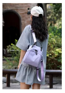 Detailed view of the women waterproof nylon backpack, stylish purple commuter travel bag.