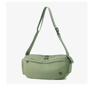 Detailed view of the casual green nylon crossbody bag featuring smooth dual zippers and durable strap.