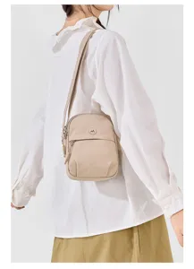 Lightweight nylon crossbody bag detail, casual beige shoulder bag with zipper pocket for daily use.