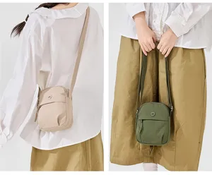 Nylon crossbody bag detail showing front pocket, zipper, and adjustable strap design.