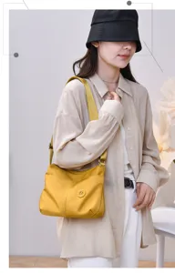 Stylish yellow nylon shoulder bag for women, casual commuter crossbody bag with pockets.