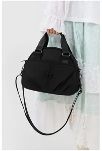 Detail view of the black nylon casual crossbody shoulder handbag for women daily commuting.