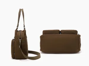 Multi-pocket nylon crossbody bag detail view showing side and bottom storage compartments.