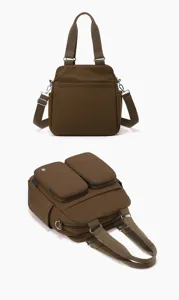 Detailed view of the brown nylon multi-pocket crossbody bag with dual handles and straps.