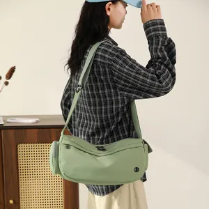 Green nylon shoulder bag for women, casual crescent crossbody bag with adjustable strap.