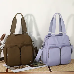 Multi-pocket nylon shoulder bag, large capacity casual tote bag for women daily commute.