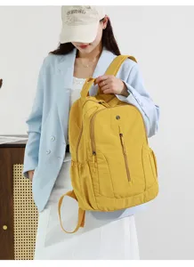 Stylish yellow casual travel backpack, lightweight waterproof design with large capacity.