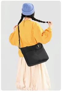 Minimalist black nylon shoulder bag detail, large capacity design for daily commute work.