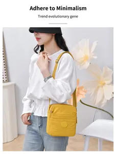 Casual multi-compartment nylon crossbody shoulder bag, lightweight waterproof phone bag.