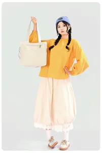 Detailed view of the casual nylon tote bag in beige, showing front pocket and durable handles.