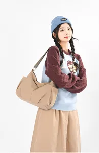 Discover this lightweight multi-pocket nylon shoulder bag, offering large capacity and lazy style.