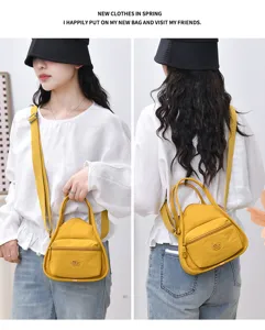 Vue détaillée du sac bandoulière en nylon jaune, poche avant et poignée robuste bien visibles.