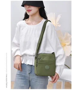 Casual multi-compartment nylon crossbody bag for women, lightweight waterproof shoulder bag.