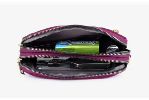 Nylon multi-zipper crossbody bag for women, casual travel shoulder bag with large capacity interior.
