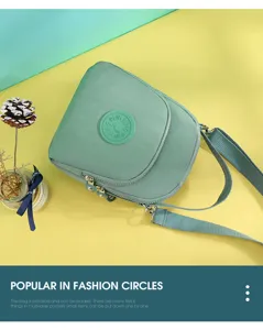 Green nylon crossbody shoulder bag, lightweight multi-layer pocket casual daily handbag.