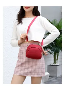 Red nylon crossbody bag with shoulder strap and top handle, casual daily mini handbag for women.