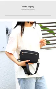 Black nylon crossbody bag for women, lightweight casual shoulder bag with zipper pocket.
