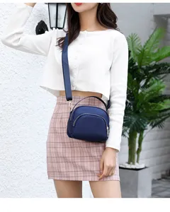 Stylish women's small canvas crossbody bag with shoulder strap and zipper design for daily use.