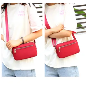 Stylish red nylon crossbody bag for women, casual small square shoulder bag with zipper.