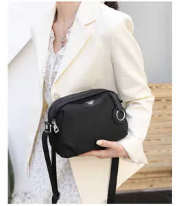 Stylish black oxford cloth crossbody bag for women, versatile daily shoulder bag with zipper.
