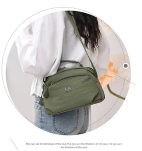 Casual nylon crossbody bag for women, multi-layer stylish shoulder bag with handle.
