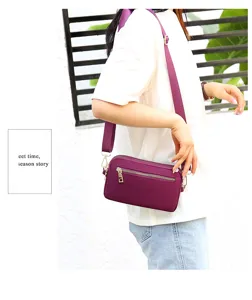 Purple nylon crossbody bag for women, stylish multi-pocket shoulder bag for daily travel use.