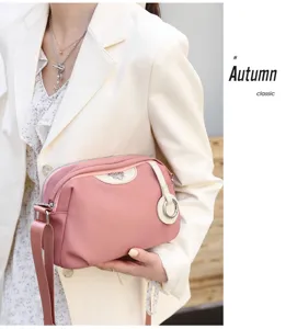 Pink nylon shoulder bag for women, casual crossbody bag with trendy design and strap.