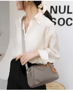 Women casual oxford cloth crossbody shoulder bag with stylish brown leather trim and metal ring.