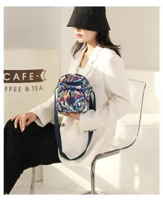 Detailed view of fashionable printed nylon crossbody bag with secure zipper and strap.