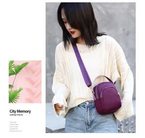 Detail view of purple nylon crossbody bag with wide strap and multi-pocket daily casual style