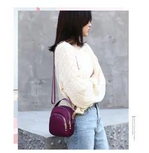 Nylon crossbody bag for women, lightweight purple shoulder bag with multi-pocket design.