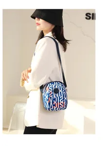 Detail view of the trendy printed oxford crossbody bag worn by model, showing casual style.