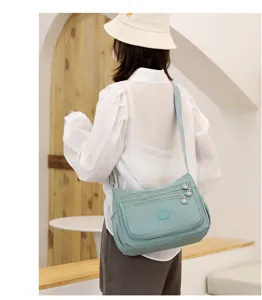 Detailed view of women casual oxford cloth crossbody shoulder bag with multi-layer zipper pockets.