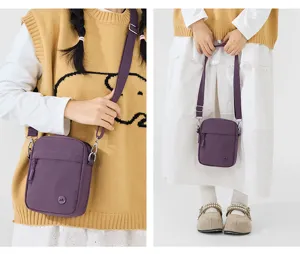 Detail view of the purple mini crossbody shoulder bag showcasing quality fabric and metal hardware.