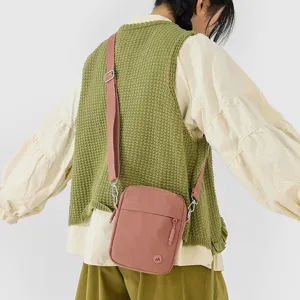 Minimalist women's crossbody small square bag, casual daily shoulder phone bag worn by model.