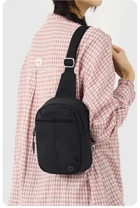 Vue détaillée du sac de poitrine en nylon noir, montrant la sangle et la fermeture.