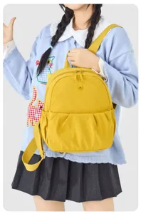 Yellow casual canvas mini backpack for women, lightweight travel daypack with front pocket.