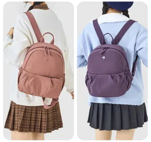 Detail view of casual mini backpack showcasing front pocket and comfortable shoulder straps.
