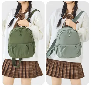 Casual canvas mini backpack for women, compact travel daypack with front pocket and dual straps.