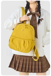 Casual yellow mini backpack for women, lightweight canvas daypack for daily travel and school.