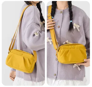 Yellow nylon crossbody bag detailed view, lightweight multi-layer shoulder purse for women.