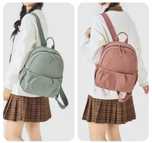 Casual small backpack for women, lightweight nylon daily daypack in green and pink colors.