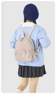 Casual lightweight canvas mini backpack detailed view, showing adjustable straps and front pocket.